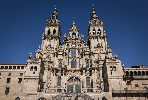 Santiago de Compostela Archcathedral Basilica (Catedral Basilica de Santiago de Compostela) under deep blue summer sky. The archcathedral basilica is a place of pilgrimage on the Way of St James since the Early Middle Ages and marks the traditional end of the pilgrimage route - Camino de Santiago. It`s a Romanesque structure, with Gothic and Baroque additions. Santiago de Compostela, A Coruña Province, Galicia, Spain, Europe