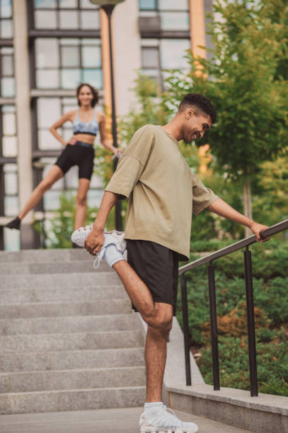 istock Young couple exercising together and looking happy 1438308377