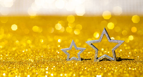 istock Christmas stars on shiny golden background 1438308703