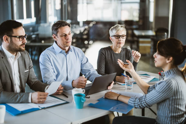 istock Human resource team talking to female candidate on a job interview. 1438309958
