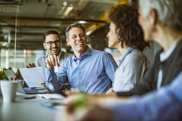istock Happy entrepreneur talking to his colleagues in the office. 1438310032