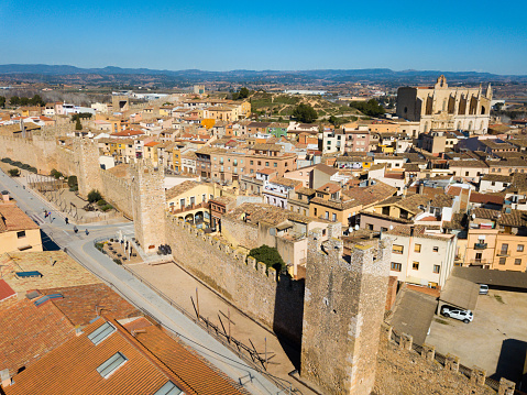 View from drone of Montblanc cityscape with battlements of fortress wall, Tarragona, Spain