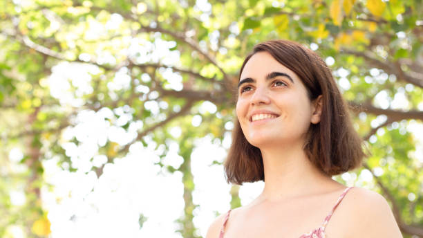 istock Low angle shot of a young female posing in a park 1438313076