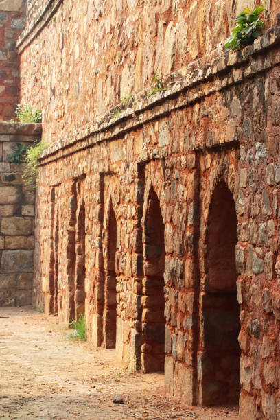 istock Close-up image of red brick mughal wall with arch architectural feature, focus on foreground 1438313135