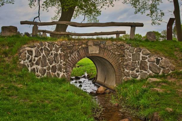 An old bridge with wooden railings over a small creek