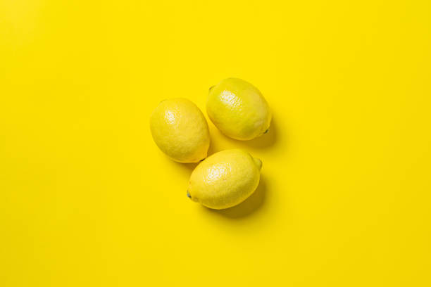 istock Top view of lemons on yellow background with an empty space for a text 1438314105
