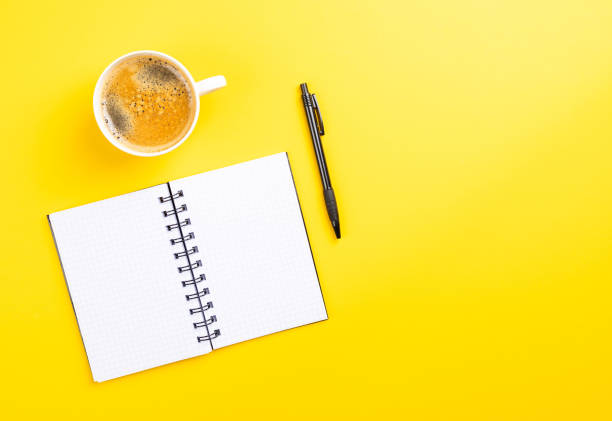 istock Flat lay of the office working tools on the yellow surface - space for text 1438314176