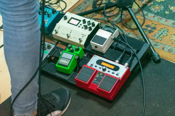 A selective focus shot of professional pedalboard, electric guitar pedal set