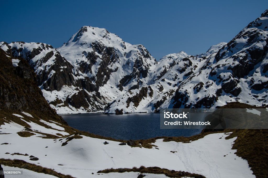 Routeburn Track with mountains covered with snow in New Zealand The Routeburn Track with mountains covered with snow in New Zealand Cold Temperature Stock Photo