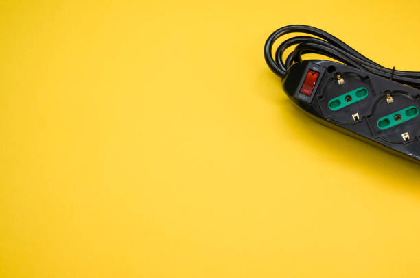 istock Black surge protector on a yellow background 1438315403
