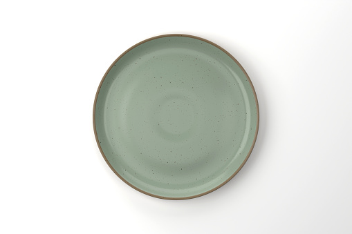 Green Ceramic Plate On White Background. Modern Empty Plate.