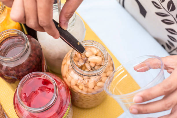 istock Adding beans into a clear plastic cup. Making Halo-halo, a FIlipino dessert. 1438315629