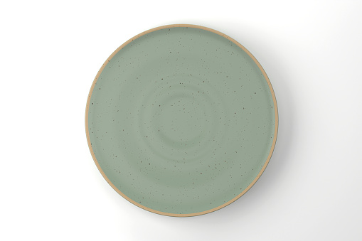 Green Ceramic Plate On White Background. Modern Empty Plate.