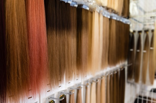 The view of hairpieces displayed in the store in different shades