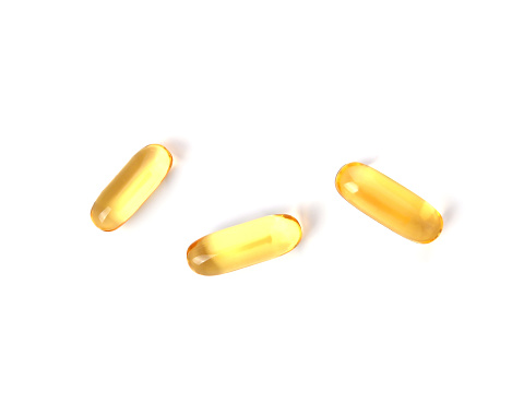 Primrose oil capsules isolated on white background. Top view