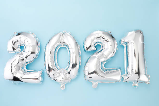 istock '2021' made with silver balloon numbers on a blue background 1438316487