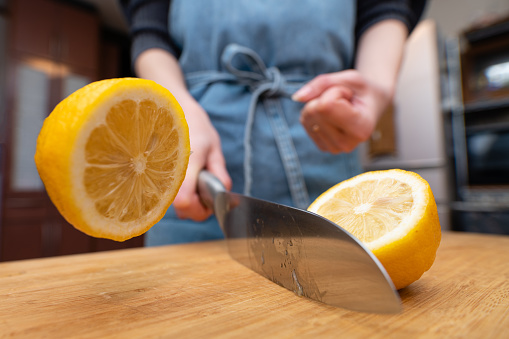 Woman cutting lemons in the kitchen