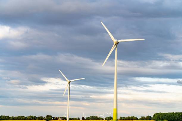 istock Group of wind turbines against a blue clouded sky 1438317694