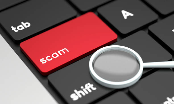 istock Close-Up Laptop Keyboard With Scam Button and Magnifying glass 1438318303