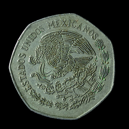The 1977 Mexican Ten Pesos coin isolated on the black background