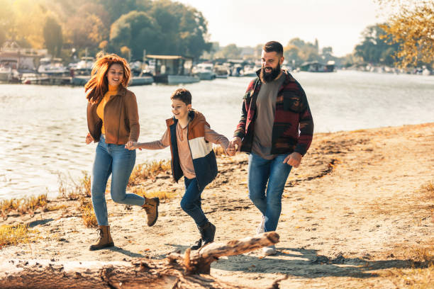 istock Parents and son walking near river spending vacation 1438320641