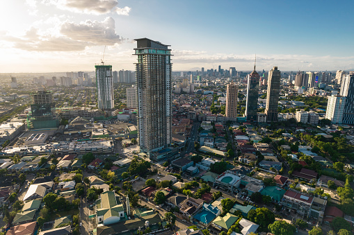 San Juan, Metro Manila, Philippines - May 2022: Beautiful afternoon aerial of Greenhills shopping district. Several residential towers stand out from the lowrise houses.
