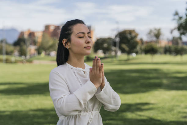 istock Hispanic female doing yoga at a park 1438320987
