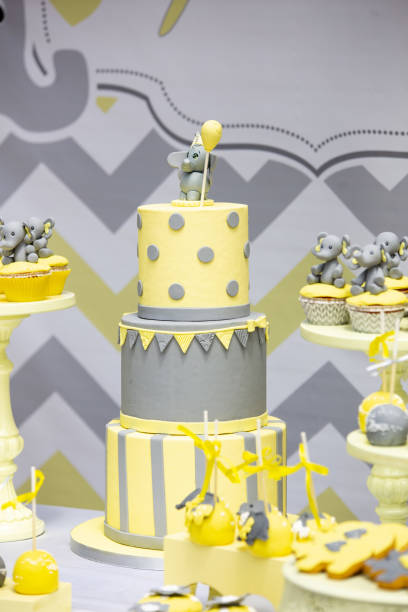 istock Three-floor cake and cupcakes decorated with elephants on the table during a birthday party 1438321011