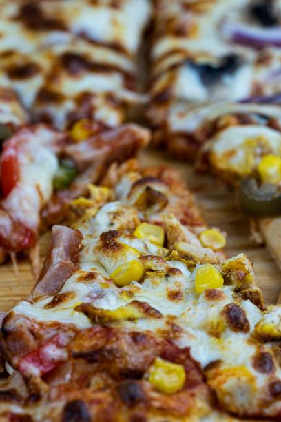 istock Vertical closeup shot of a pizza piece 1438321555