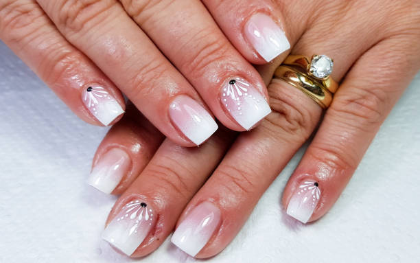 istock Closeup of a simple white gradient manicure on square-shaped nails 1438321894