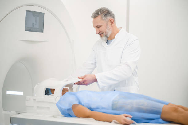 istock Female patient lying on a couch before MRI scanning 1438324229