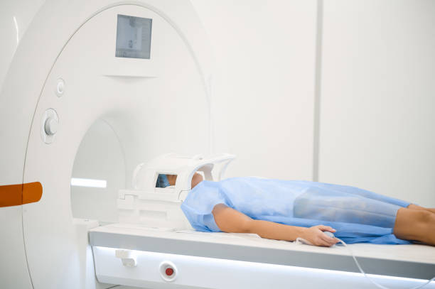 istock Female patient lying on a couch before MRI scanning 1438324247