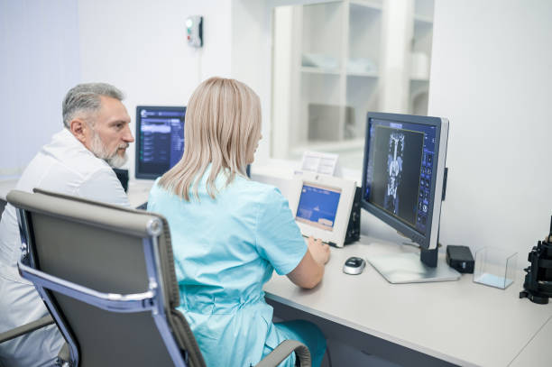 istock Medical specialists sitting at the computer and analyzing the investigation results 1438324313