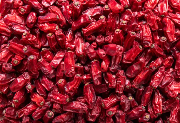 Close up view of dried Berberis vulgaris also known as common barberry, European barberry or barberry on plate in home kicthen. Edible herbal medicinal red fruit.