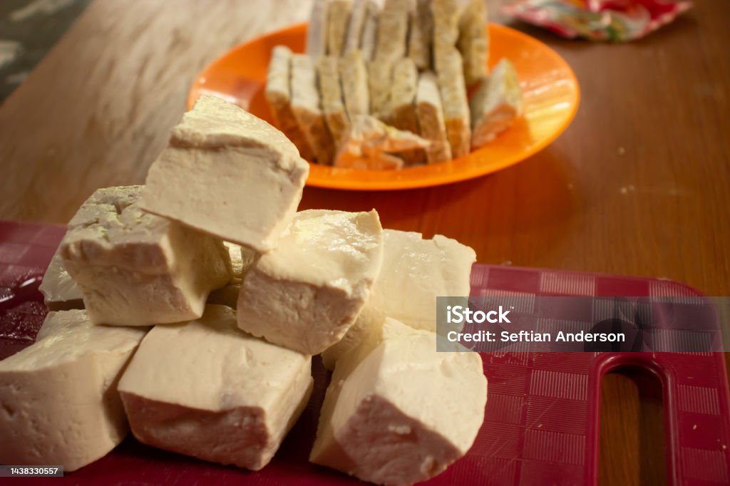 Tempe and tofu in their respective containers on a chocolate table Brown Stock Photo