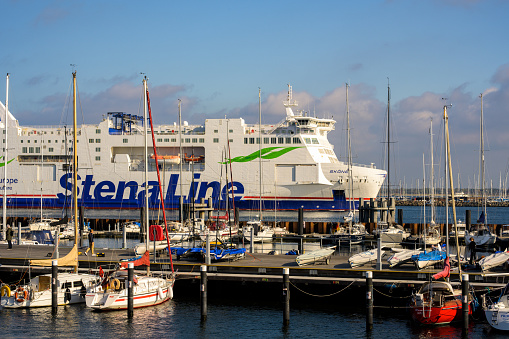 Warnemünde, Germany - October 15, 2022: Stena Line Scandinavica ferry approaching Rostock Warnemünde Harbor, in the foreground Dockside of Warnemünder Sailing Club e.V. Warnemünde