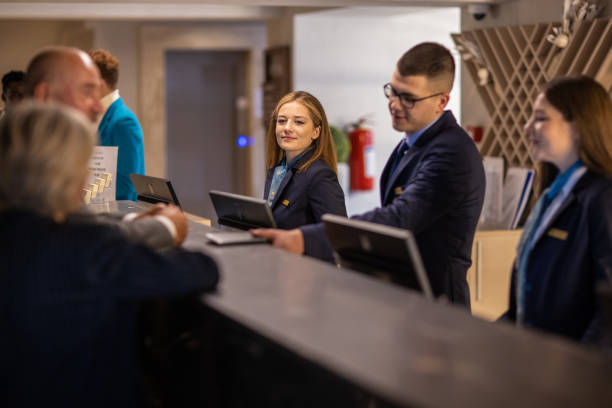 istock Businessman checking into a hotel at the reception desk 1438332093