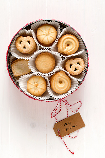 Christmas, butter cookie, in a gift box, on wooden white table. Top View. Copy space.