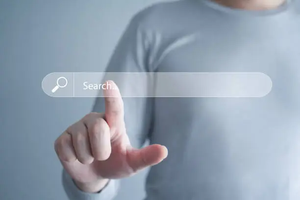 Photo of Data Search Technology Search Engine Optimization (SEO). Man's hands are touch on virtual search bar for surfing the internet and Searching for information on web browser.