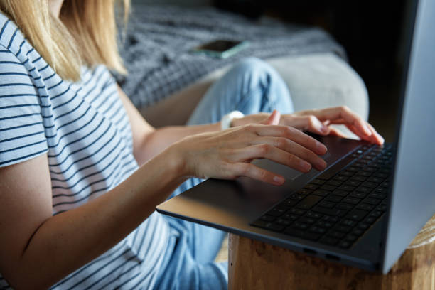 istock Woman hands typing on laptop keyboard 1438337993