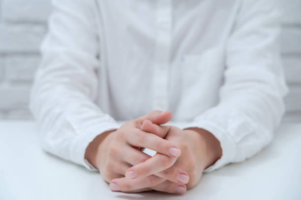 istock Hands in white shirt on white table. Business concept 1438338183
