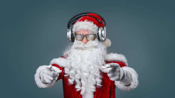 Cool Santa Claus is listening music in headphones Cool Santa Claus is listening music in headphones traditional song stock pictures, royalty-free photos & images