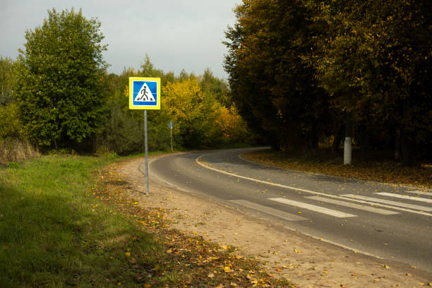 turning road. pedestrian crossing across street. track details. - corner marking fotos imagens e fotografias de stock