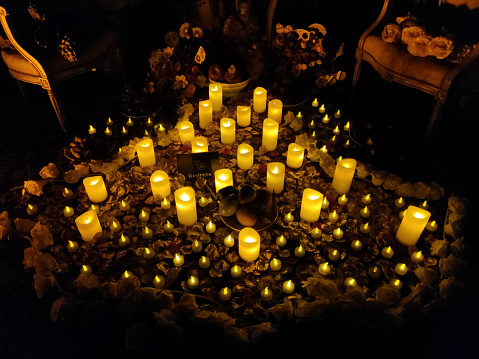Abandoned creepy mansion with dozens of candles lit for the night of the Dia de los Muertos.