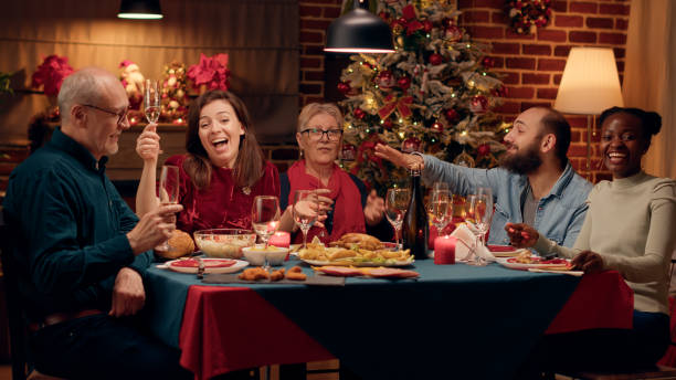 istock Happy smiling people laughing heartily while talking to camera at Christmas dinner 1438339601