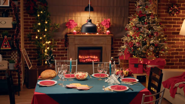 istock Empty festive christmas dinner table inside decorated living room with holiday garlands and dinnerware 1438339751
