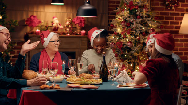 istock Positive diverse people smiling heartily while enjoying Christmas dinner at home with loved ones. 1438341297