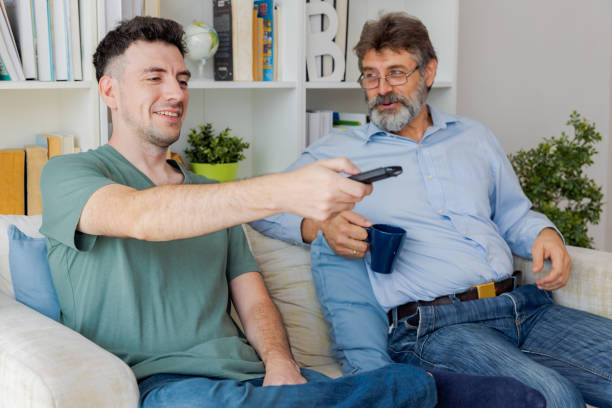 istock Family watching tv together. 1438342799