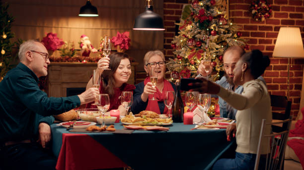istock Joyful multiracial family members taking selfie photos with smartphone device while sitting at Christmas dinner table 1438342803