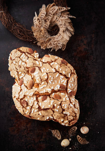 Colomba Pasquale, Italian Easter Dove Sweet Bread Colomba di Pasqua on dark surface. Selective focus. space for text. Colomba Pasquale, Italian Easter Dove Sweet Bread Colomba di Pasqua on dark surface. Selective focus, space for text. Traditional dessert in Italy. Top view. knif stock pictures, royalty-free photos & images